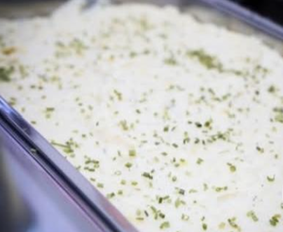 Pan of creamy potato salad with chives
